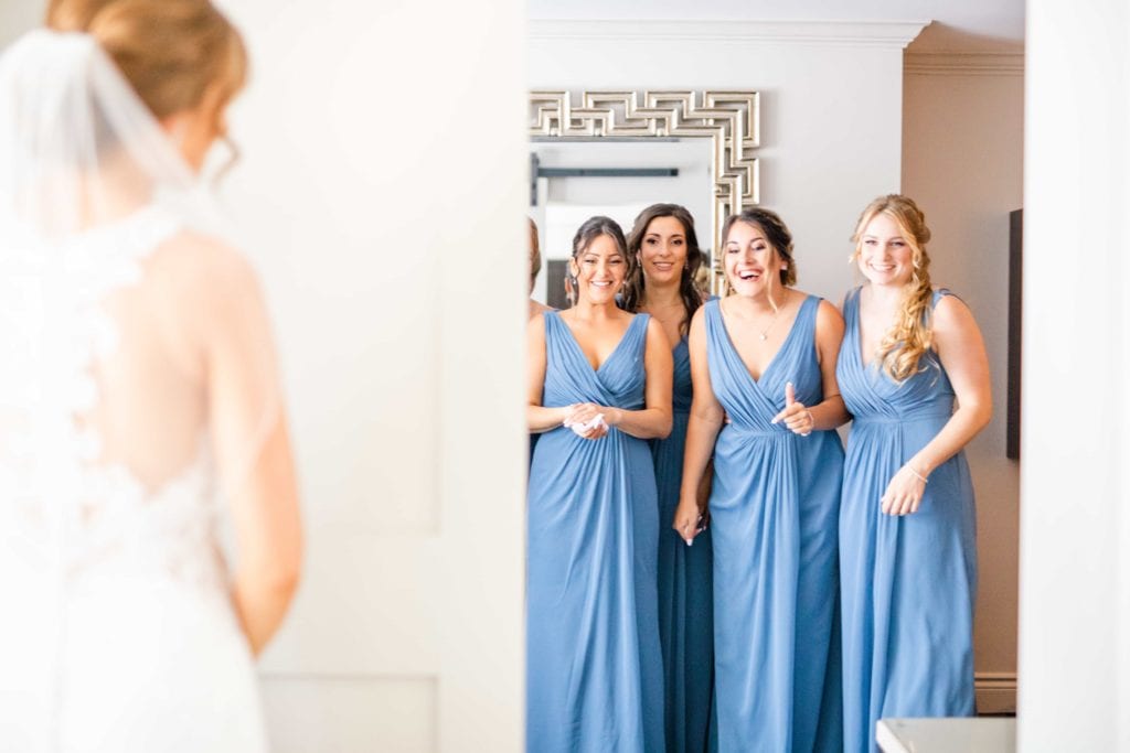 bridesmaids seeing bride for first time on wedding day